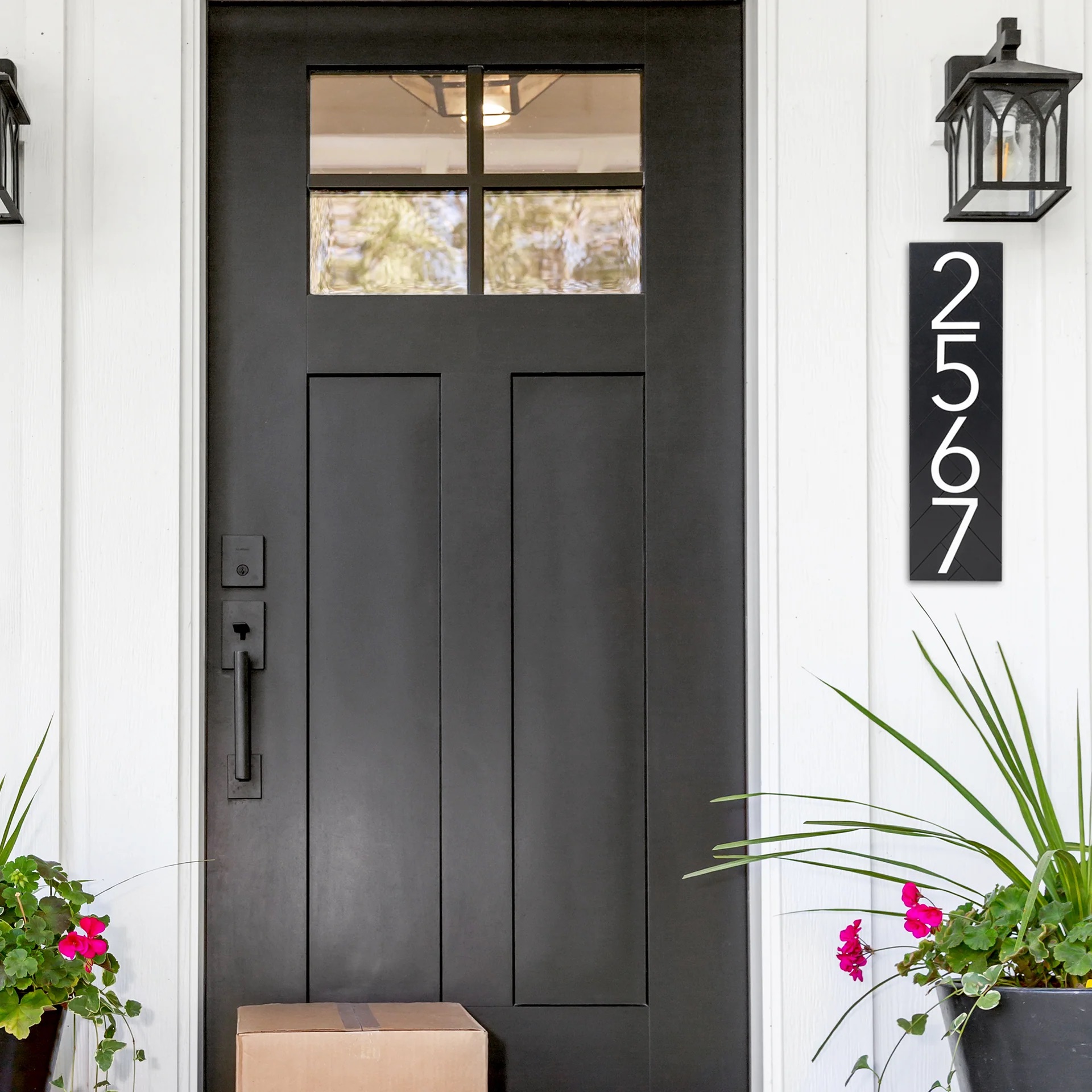 Modern vertical black address sign mounted beside a craftsman front door